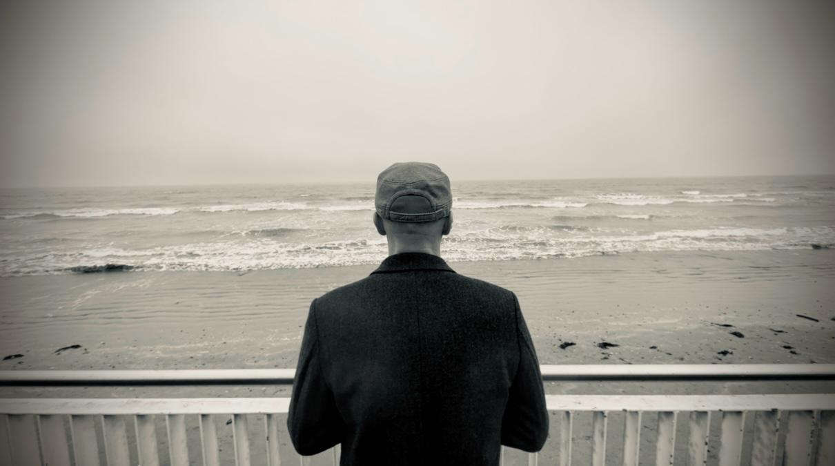 b/w picture of eoin looking out to sea with back to camera